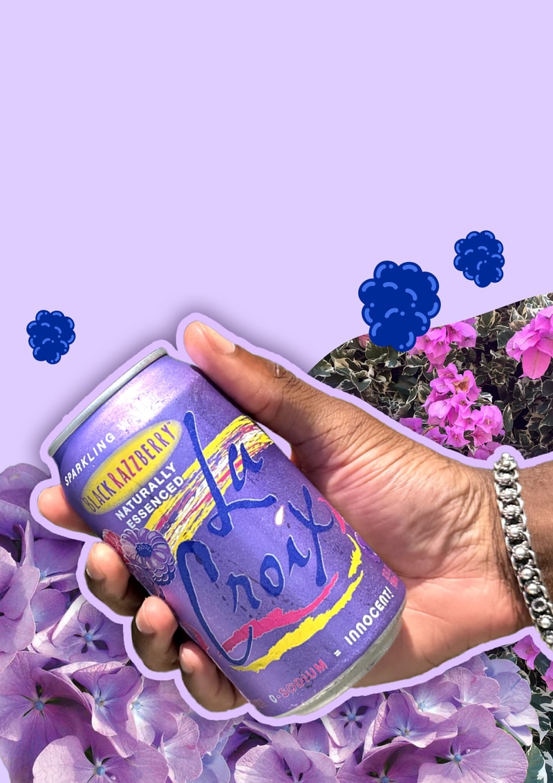 A hand holding a can of BlackRazzBerry LaCroix sparking water naturally essenced 12 fl with purple flowers, berries and the color purple in the background.